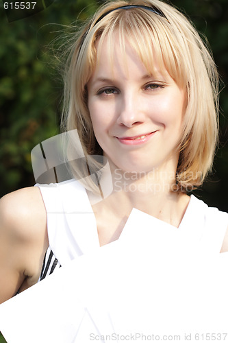 Image of Smiling blond with papers