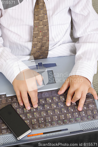 Image of Hands on old laptop