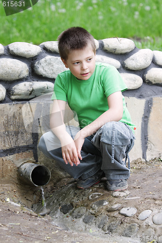 Image of Boy at spring looking aside