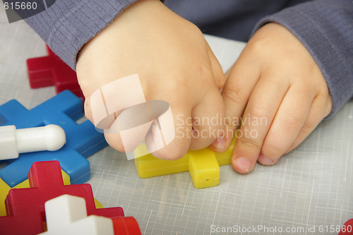 Image of Hand fixing meccano