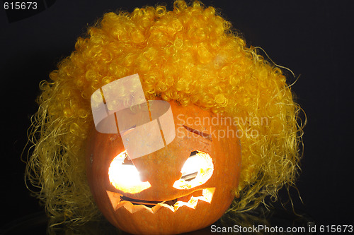 Image of Halloween pumpkin with yellow curled hairs