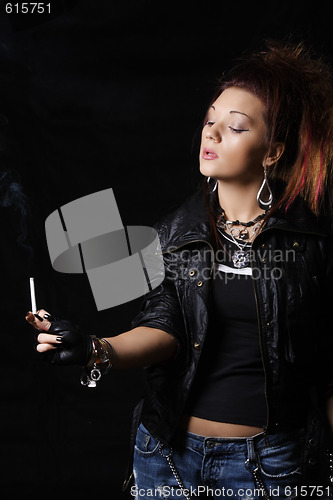 Image of Woman in black looking at cigarette
