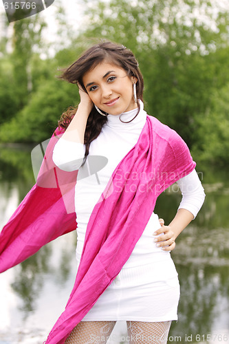 Image of Pretty girl in white and pink at lake