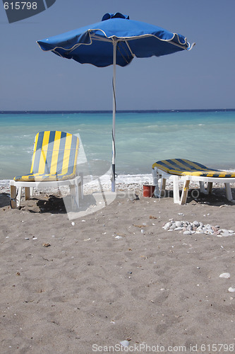 Image of Two sun-chairs and umbrella