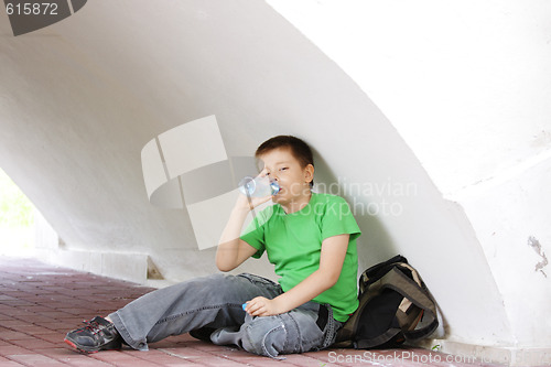 Image of Boy drinking water under arch