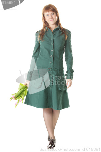 Image of Attractive redhead walking with tulips