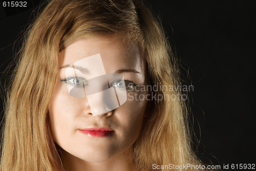Image of Portrait of girl over dark background