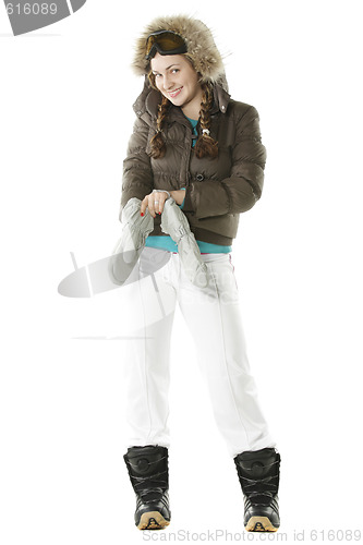 Image of Snowboarder girl wearing on gloves