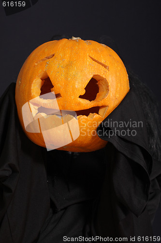 Image of Halloween pumpkin in black robe