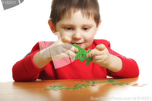 Image of Boy with green puzzles