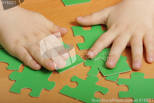 Image of Puzzles and hands