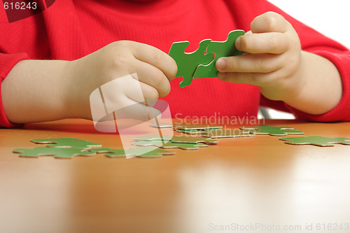 Image of Hands assembling puzzle