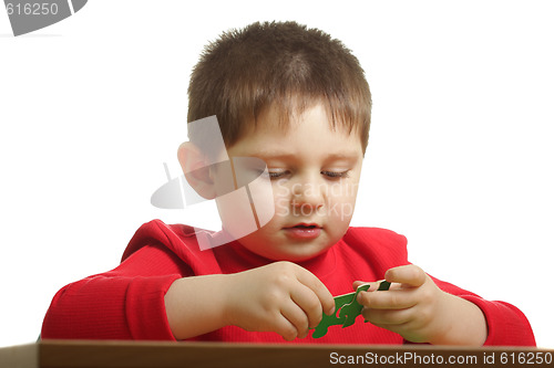 Image of Boy assembling puzzle