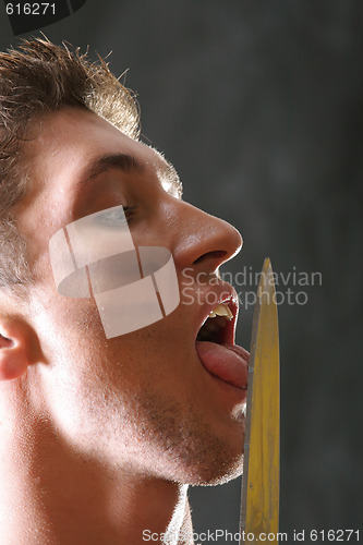 Image of Soldier licking knife blade