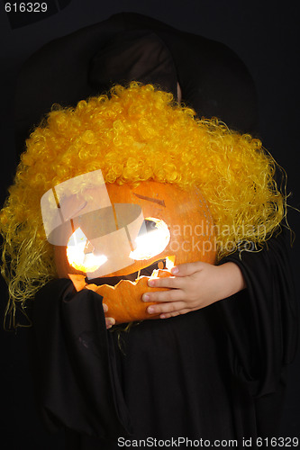 Image of Curled halloween pumpkin in child hands