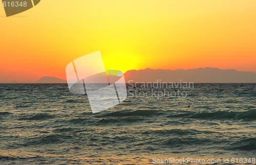 Image of Sun hiding behind mountain
