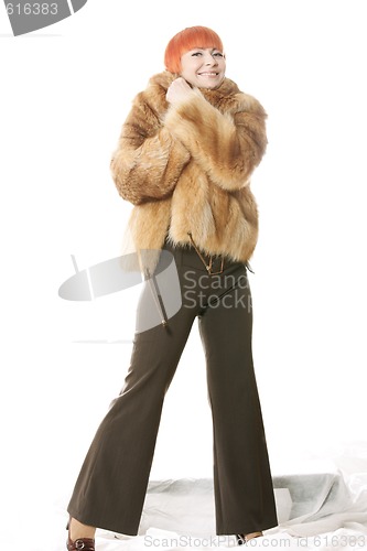 Image of Woman wrap herself in coat