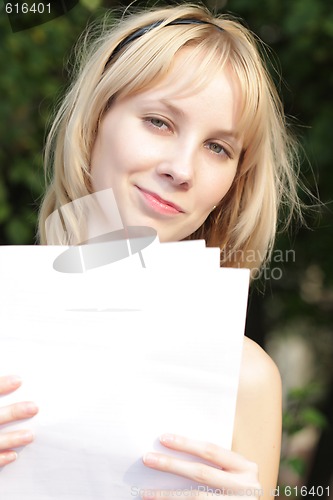 Image of Fair-haired girl with with blank papers