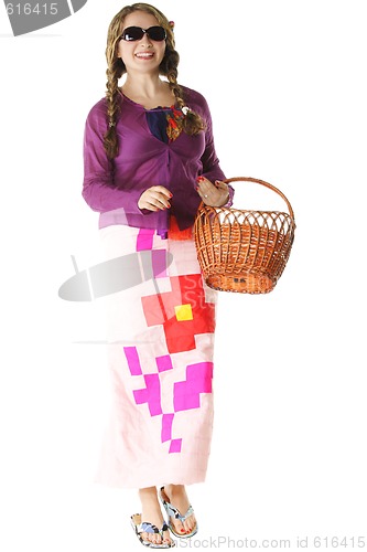 Image of Smiling young woman walking with basket