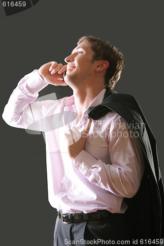 Image of Young businesman talking mobile