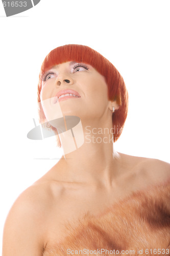 Image of Redhead in fur coat looking up