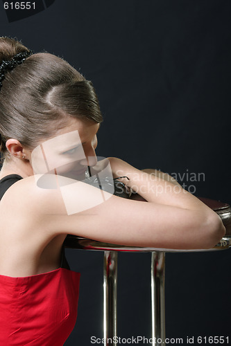 Image of Smiling girl leaning on bar chair
