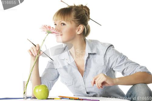 Image of Artist smelling flower
