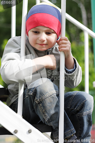 Image of Boy sitting on steps