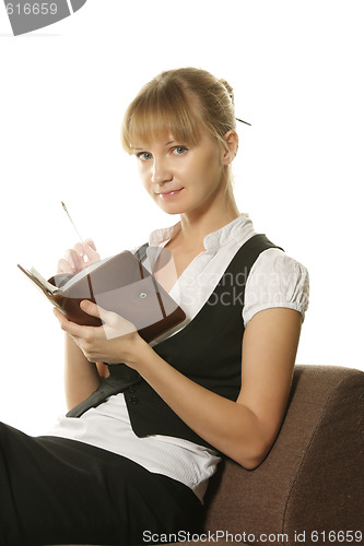 Image of Businesswoman sitting in chair with notepad