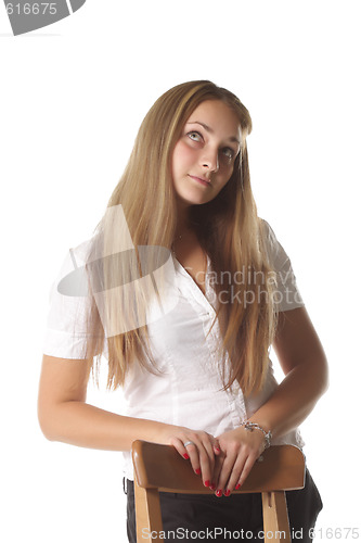 Image of Girl behind chair looking up