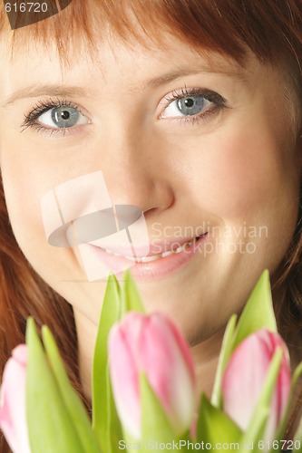 Image of Redhead with pink tulips
