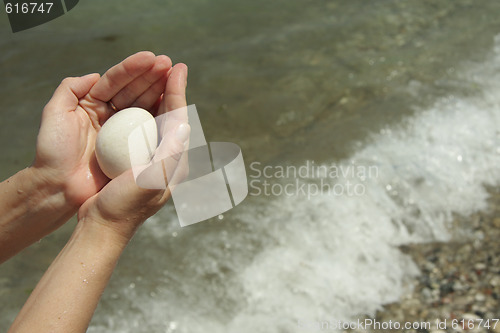 Image of White stone ball in hands