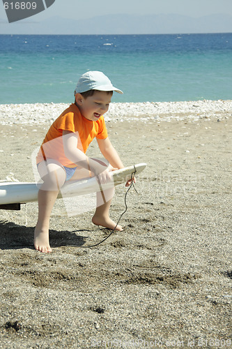 Image of Laughing boy on wind surf