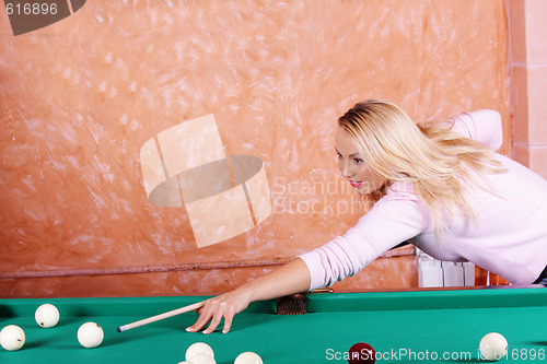 Image of Blonde in pink playing billiards