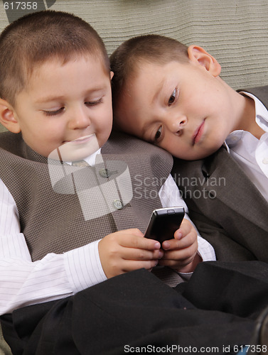 Image of Brothers looking to phone