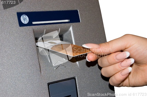 Image of Female hand inserts banking card