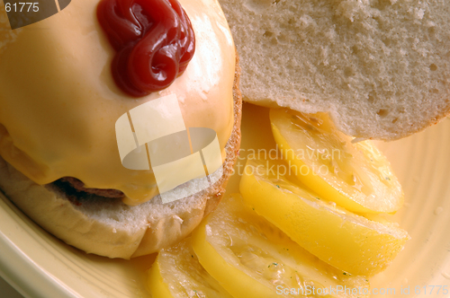 Image of cheeseburger with tomatoes ketchup