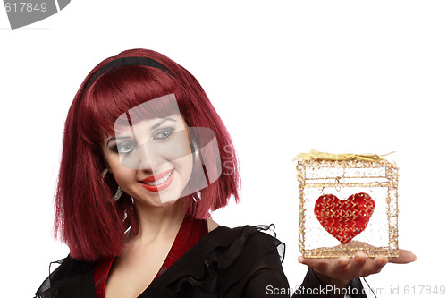 Image of Happy woman with heart packed in a golden gift box