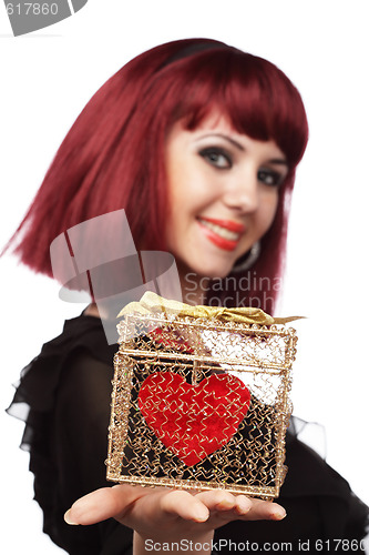 Image of Happy girl smiling with heart packed in a golden gift box