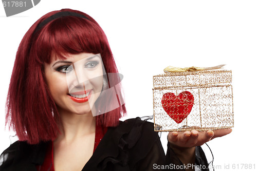 Image of Happy girl with heart in a golden gift box