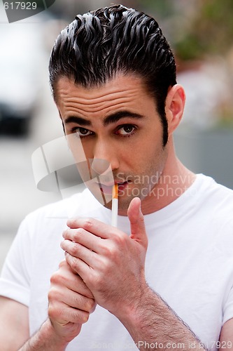 Image of Man lighting cigarette