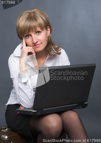 Image of thoughtful girl with  laptop