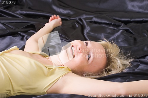 Image of happy woman on the bed