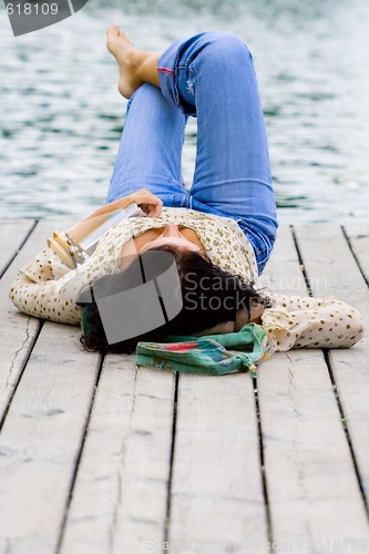Image of woman lying near the river
