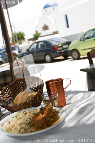 Image of lunch of greek island taverna specialty lamb with greek church i