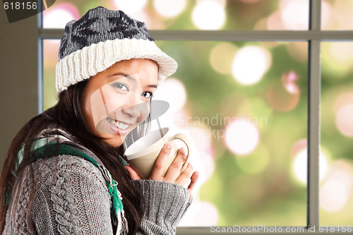 Image of Beautiful asian woman drinking coffee