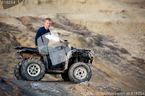 Image of teen on quad ATV in the hills