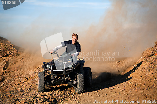 Image of teenager riding quad four wheeler