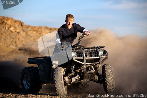 Image of teenager riding quad