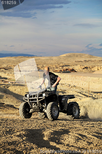 Image of quad in hills - teen on four wheeler